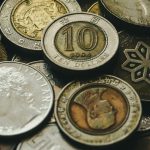 A collection of various international coins displaying different currencies and designs.