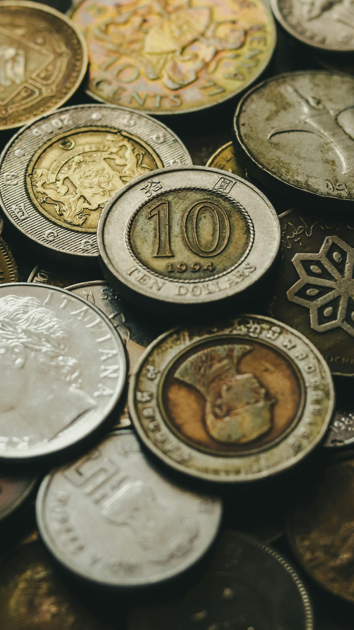 A collection of various international coins displaying different currencies and designs.