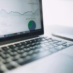 A laptop showing an analytics dashboard with charts and graphs, symbolizing modern data analysis tools.
